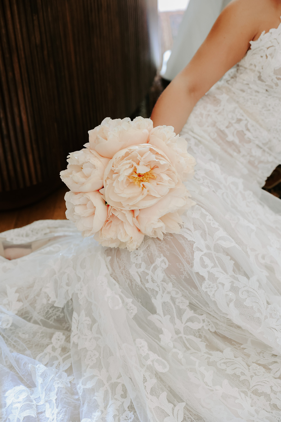 a person in a wedding dress holding a bouquet of flowers