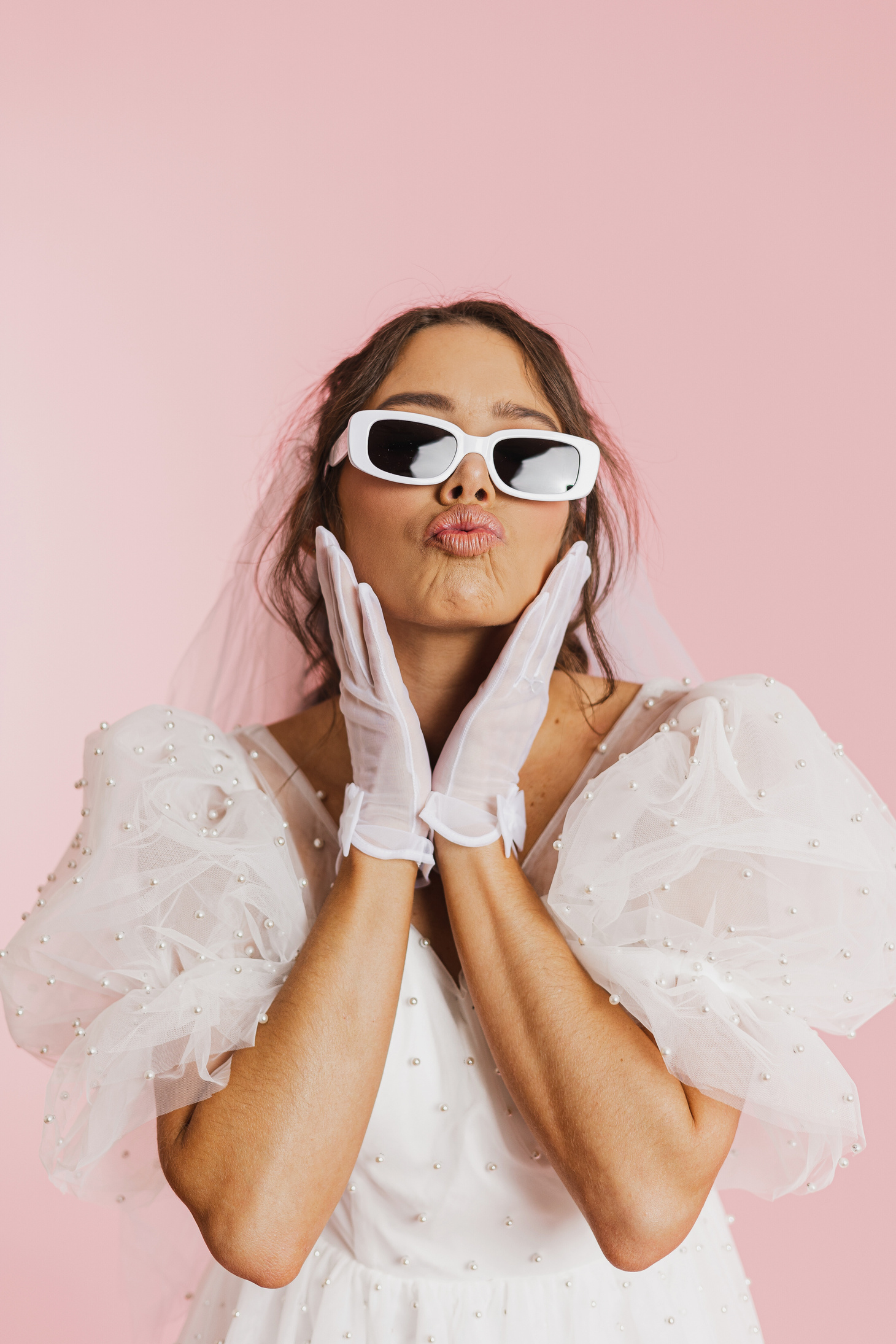 a person wearing sunglasses and a wedding dress