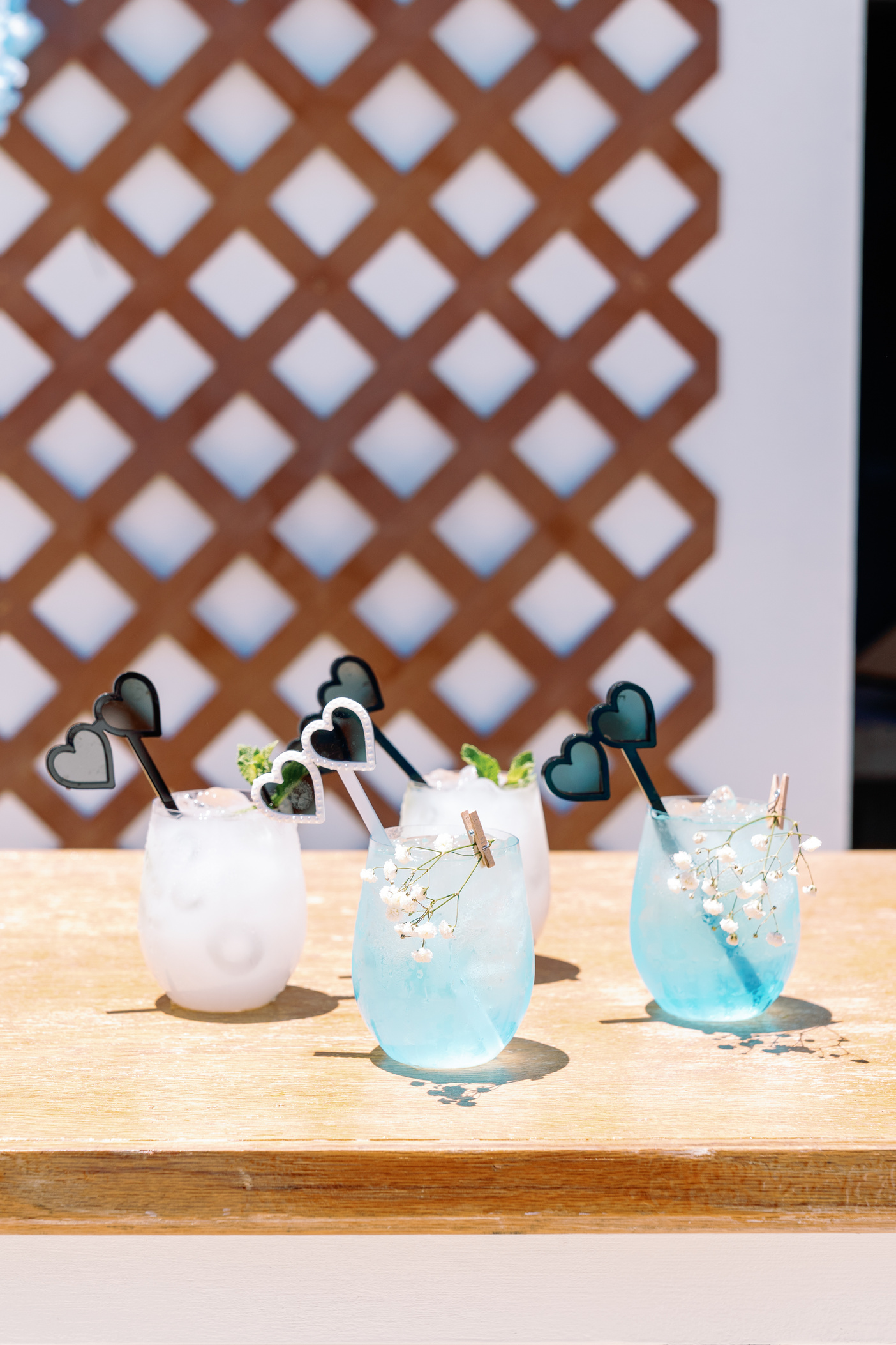 three drinks with heart shaped straws sitting on top of a table