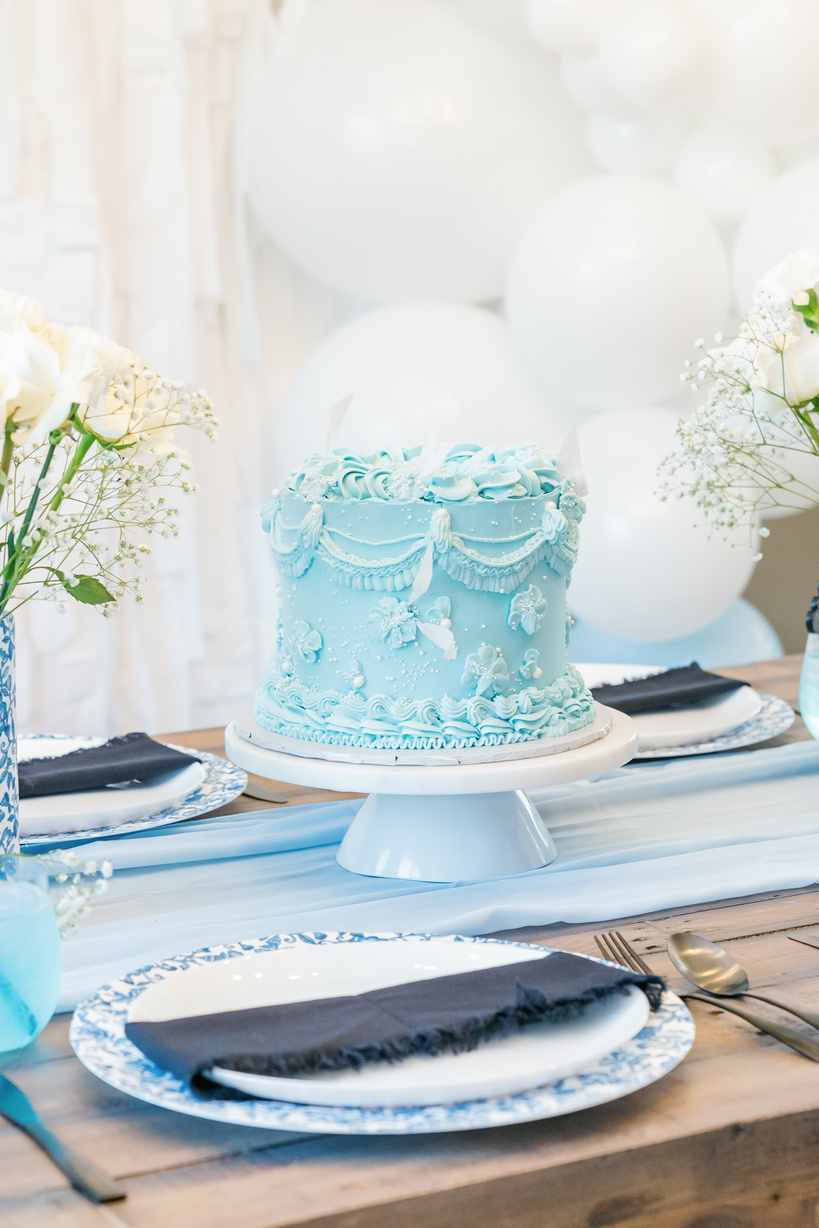 a blue cake sitting on top of a table