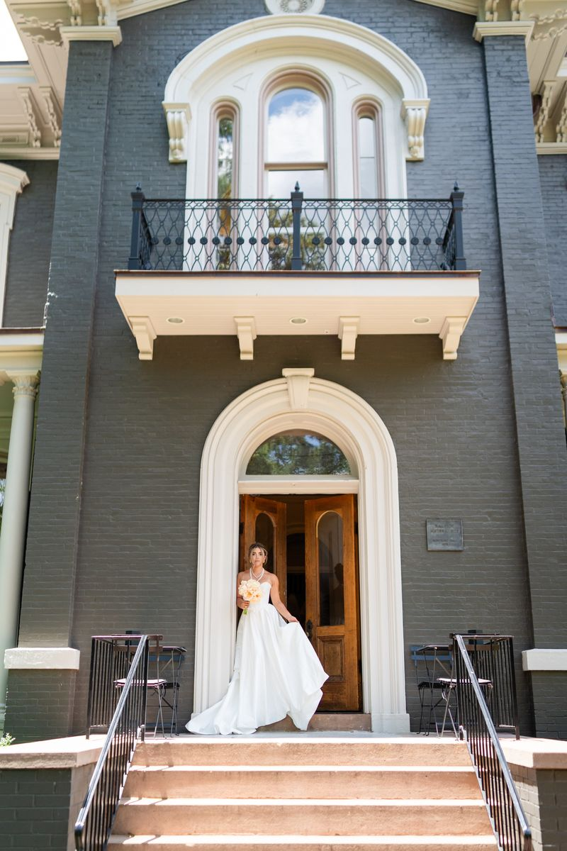 a bride standing in front of the door to her wedding